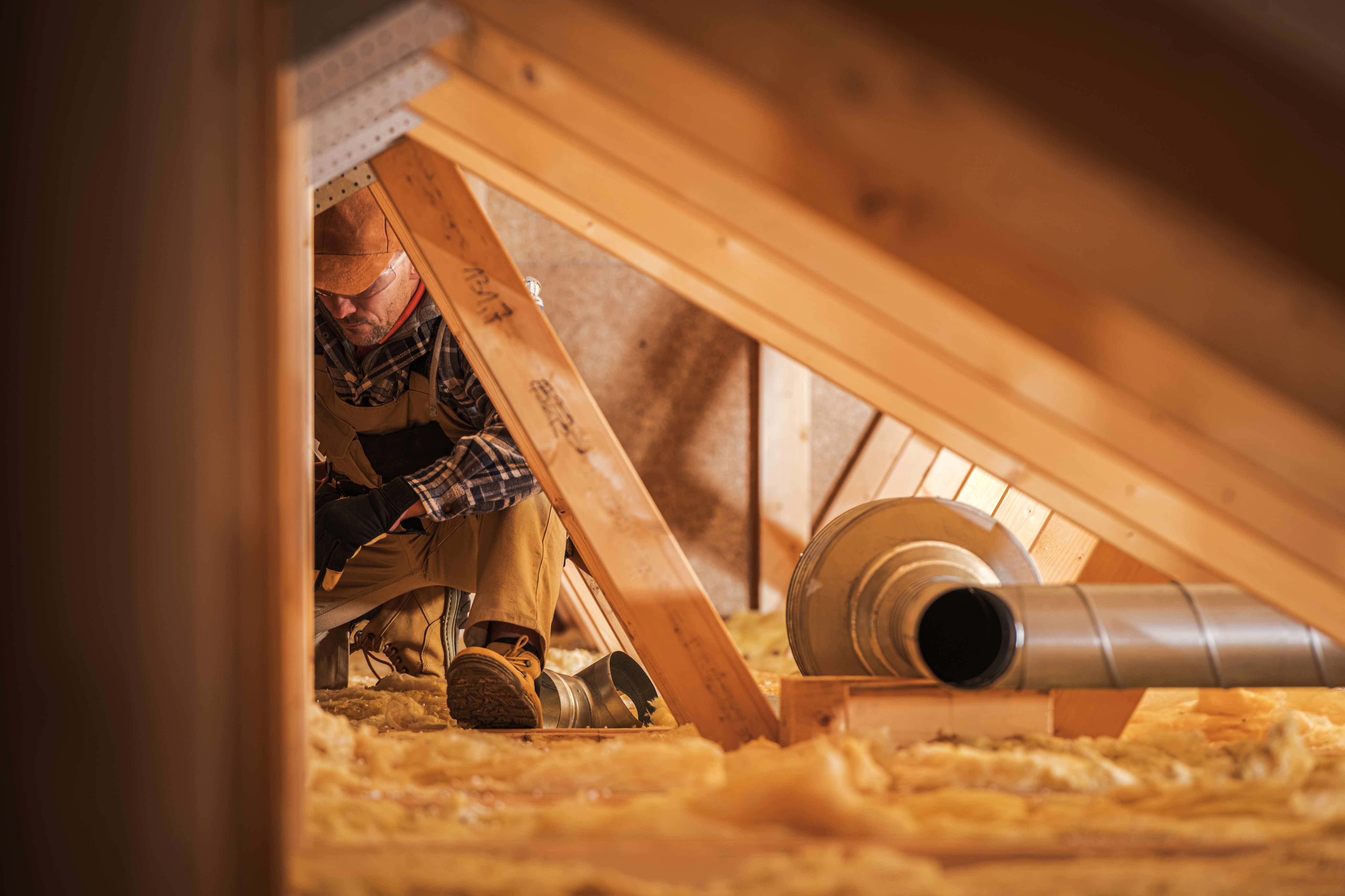Engineer installing loft insulation