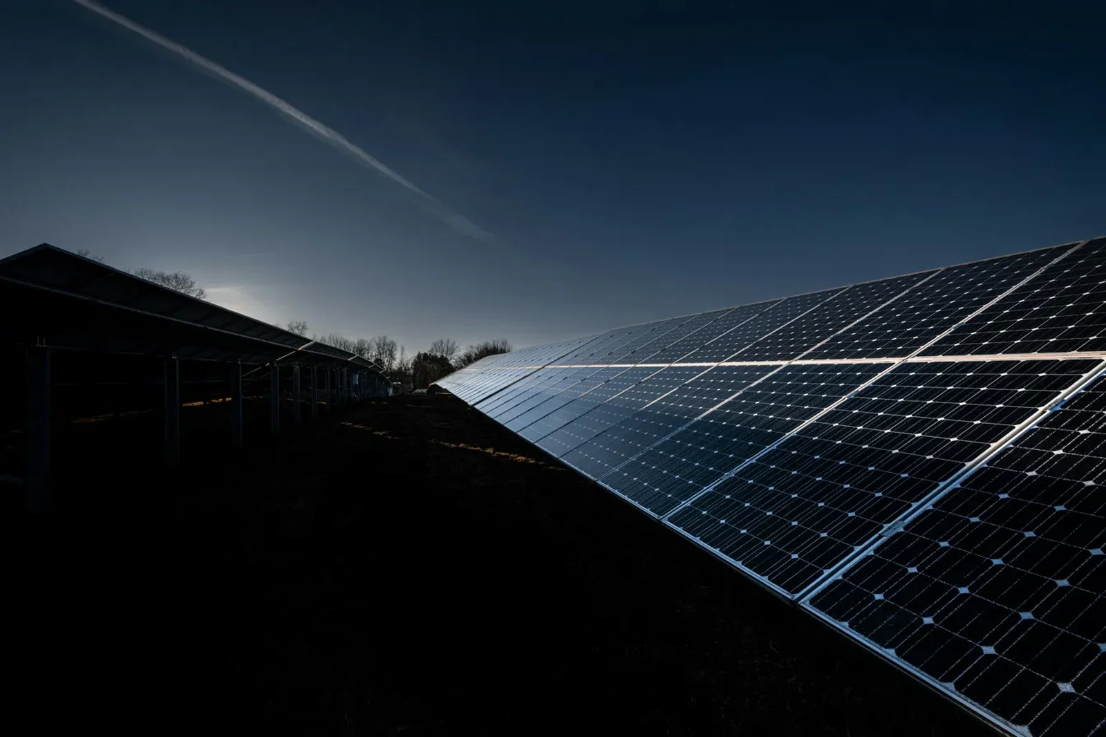 Rows of solar panels at dusk